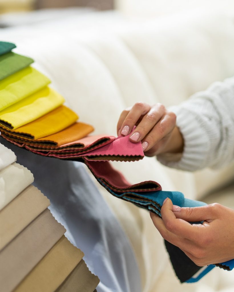 the-woman-chooses-the-fabric-on-the-sofa-textile-industry-background-tissue-catalog.jpg